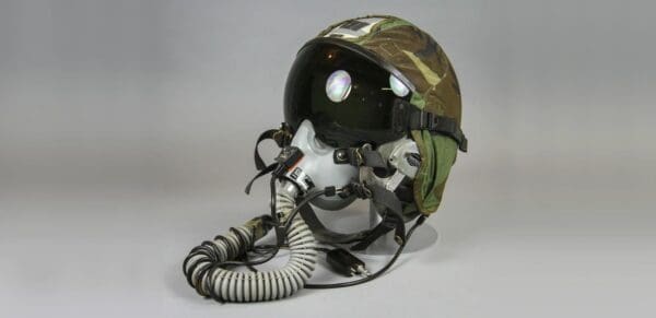 A military helmet with a hose attached to it.