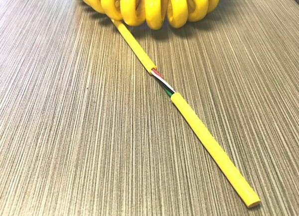 A yellow coil of wire on a table.