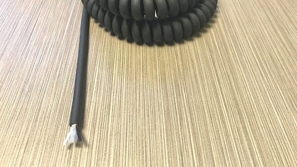 EC222 - An EC222 Electronic Coiled Cord 22 Gauge with 2 Conductors - No Shield on top of a table.