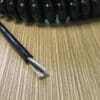 A black coiled wire on top of a table.