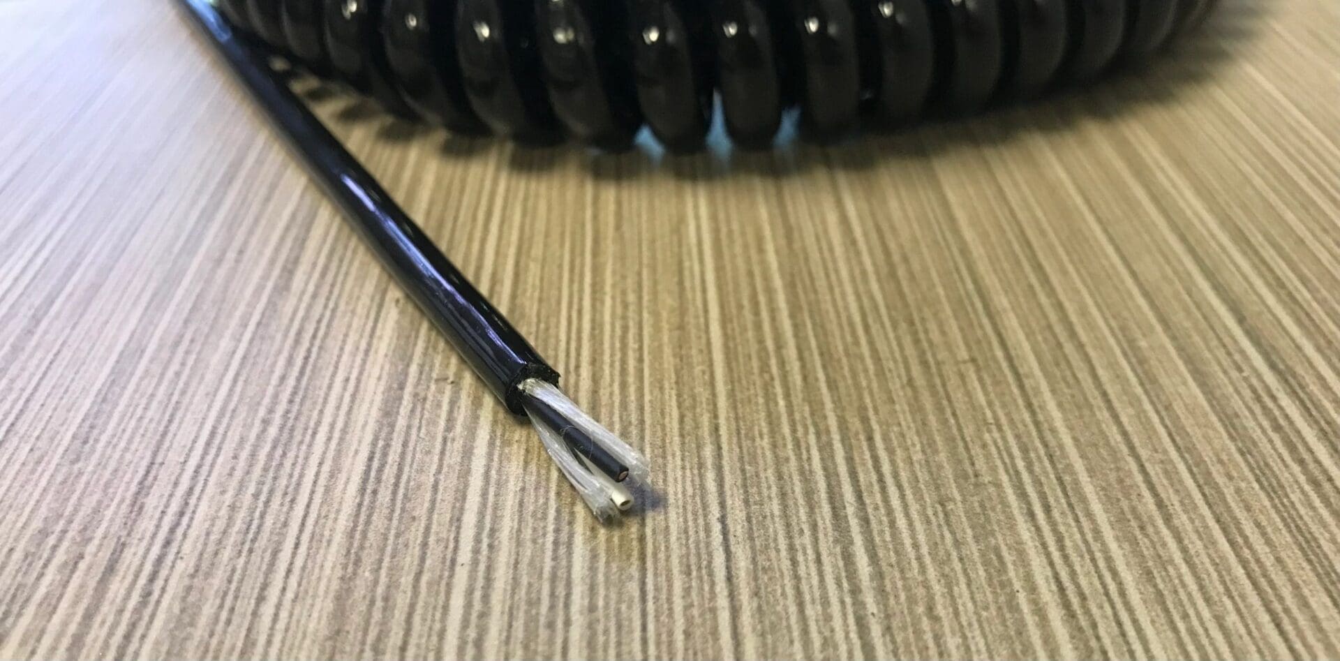 A black coiled wire on top of a table.