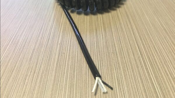 A black EC202 coiled cord on a table.