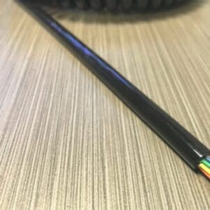 EC228 - Electronic Coiled Cord 22 Gauge with 8 Conductors - No Shield, a black cable with colored wires on top of a table.