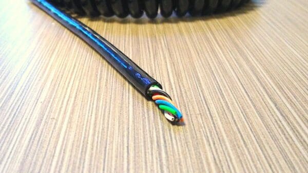 A black cable laying on top of a table.