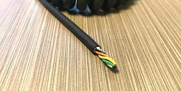 EC246 - Electronic Coiled Cord 24 Gauge with 6 Conductors - No Shield is a black cable with colored wires on top of it.