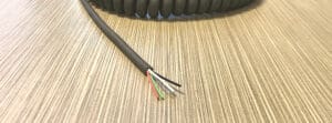 A EC284 - Electronic Coiled Cord 28 Gauge with 4 Conductors - No Shield with two wires on it.