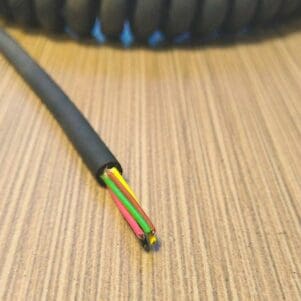 EC286 - Electronic Coiled Cord 28 Gauge with 6 Conductors - No Shield on a wooden table.