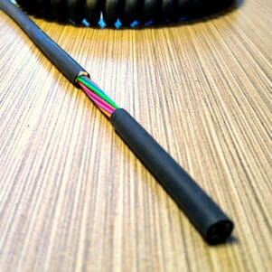 EC269 - Electronic Coiled Cable Cord 26 Gauge with 9 Conductors - No Shield on a table.