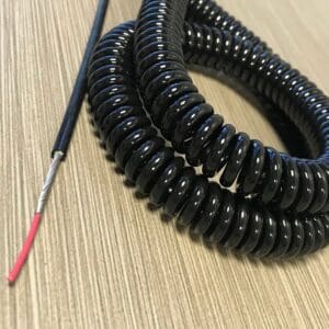 A black coiled wire on a table.