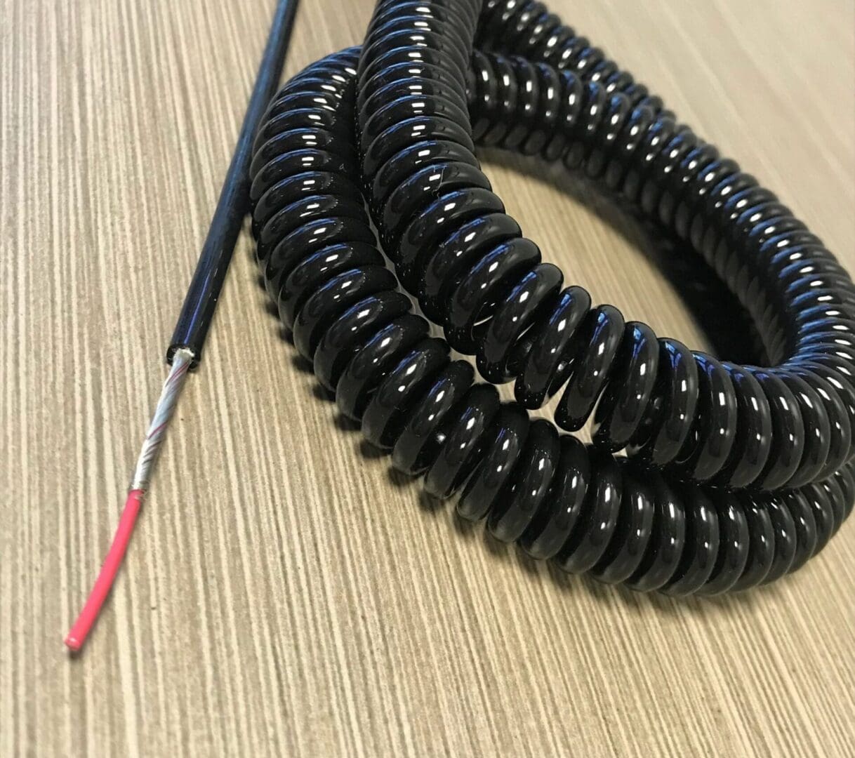 A black coiled wire on a table.