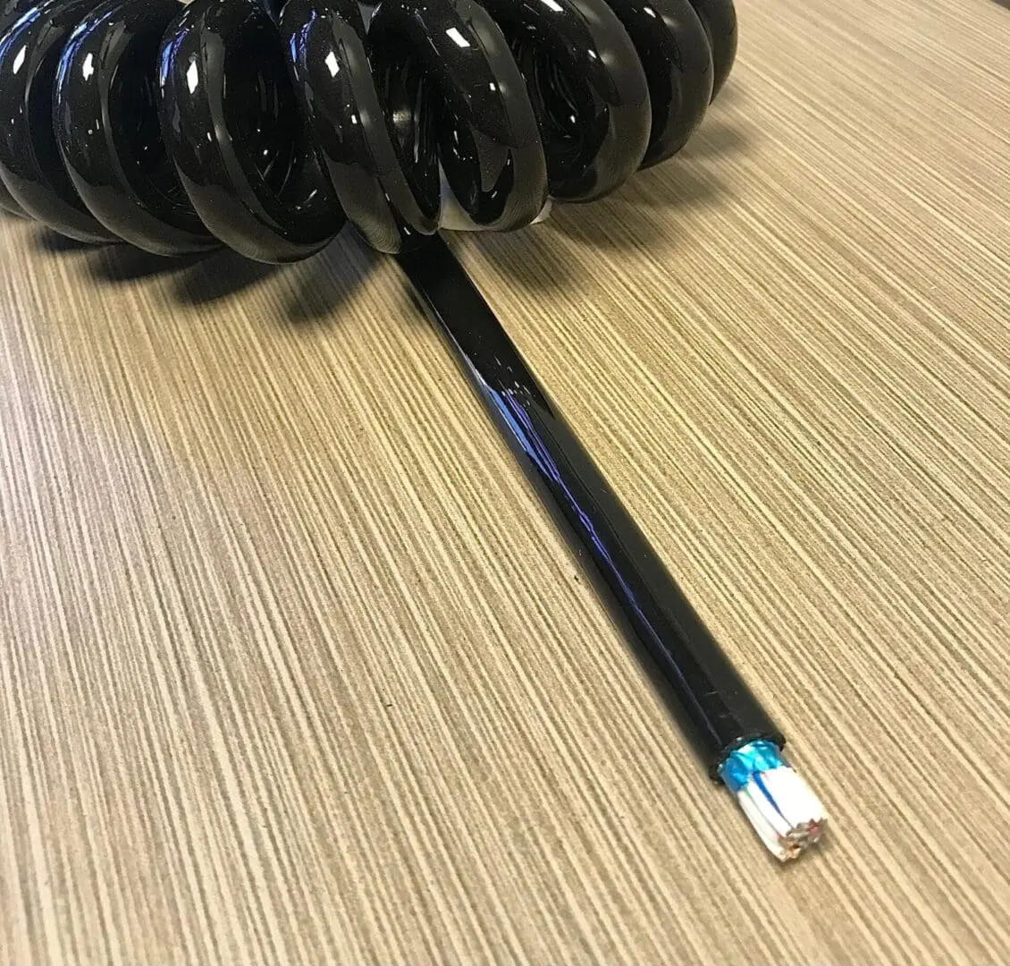 A black spiral antenna on top of a table.
