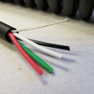 A close up of an EC204 - Electronic Coiled Cord 20 Gauge with 4 Conductors - No Shield.