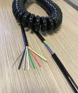 A black ECS226 - Electronic Coiled Cord 22 Gauge with 6 Conductors - Aluminum Shielded cable with different colored wires.
