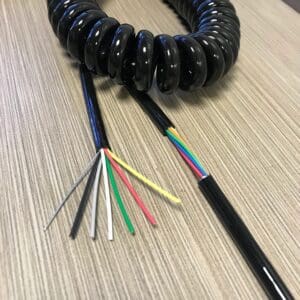 A black ECS226 - Electronic Coiled Cord 22 Gauge with 6 Conductors - Aluminum Shielded cable with different colored wires.