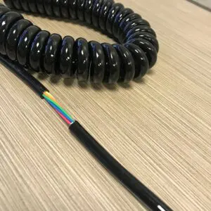 A black coiled cord on a table.