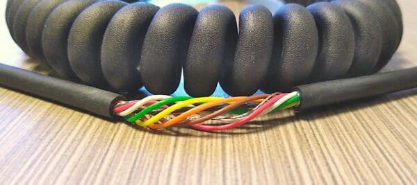 A black coiled wire on a table.