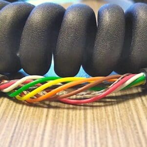 ECS287 - Electronic Coiled Cord 28 Gauge with 7 Conductors - Aluminum Shielded, on a table.