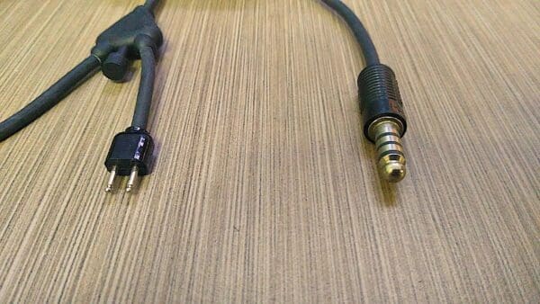 A pair of earphones connected to a cable.
