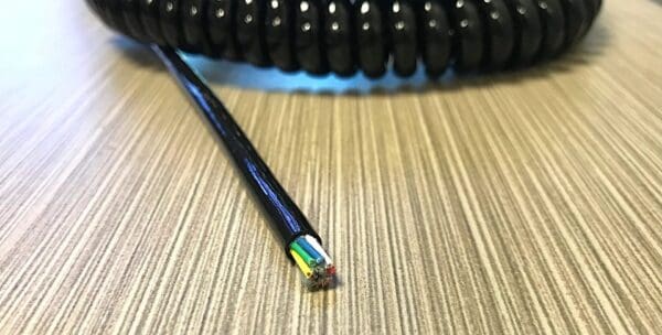 EC248 - An electronic coiled cord 24 gauge with 8 conductors - no shield on top of a table.