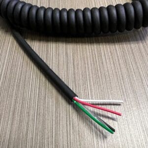 A black coiled cable on a table.