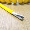 A PCE163 - Power Coiled Cord 16 Gauge with 3 Conductors - No Shield on top of a wooden table.