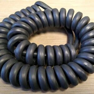 A PCO144 - Power Coiled Cord 14 Gauge with 4 Conductors - No Shield - 600 Volts - ONLINE DEAL! on a table.