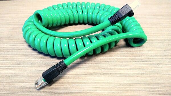 A green coiled cable on a table.