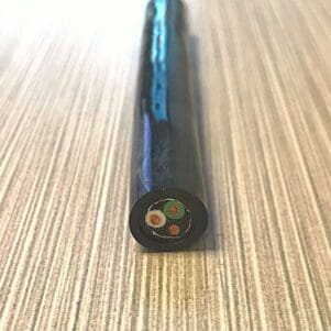 A black plastic tube on top of a wooden table.