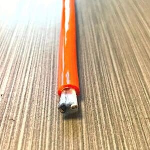 A PCE162 - Power Coiled Cord 16 Gauge with 2 Conductors - No Shield is sitting on top of a wooden table.