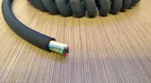 A black coiled cable on top of a table.