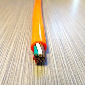 A PCE167 16 GA 7 COND. 300V COIL CABLE MAX DUTY is sitting on top of a table.