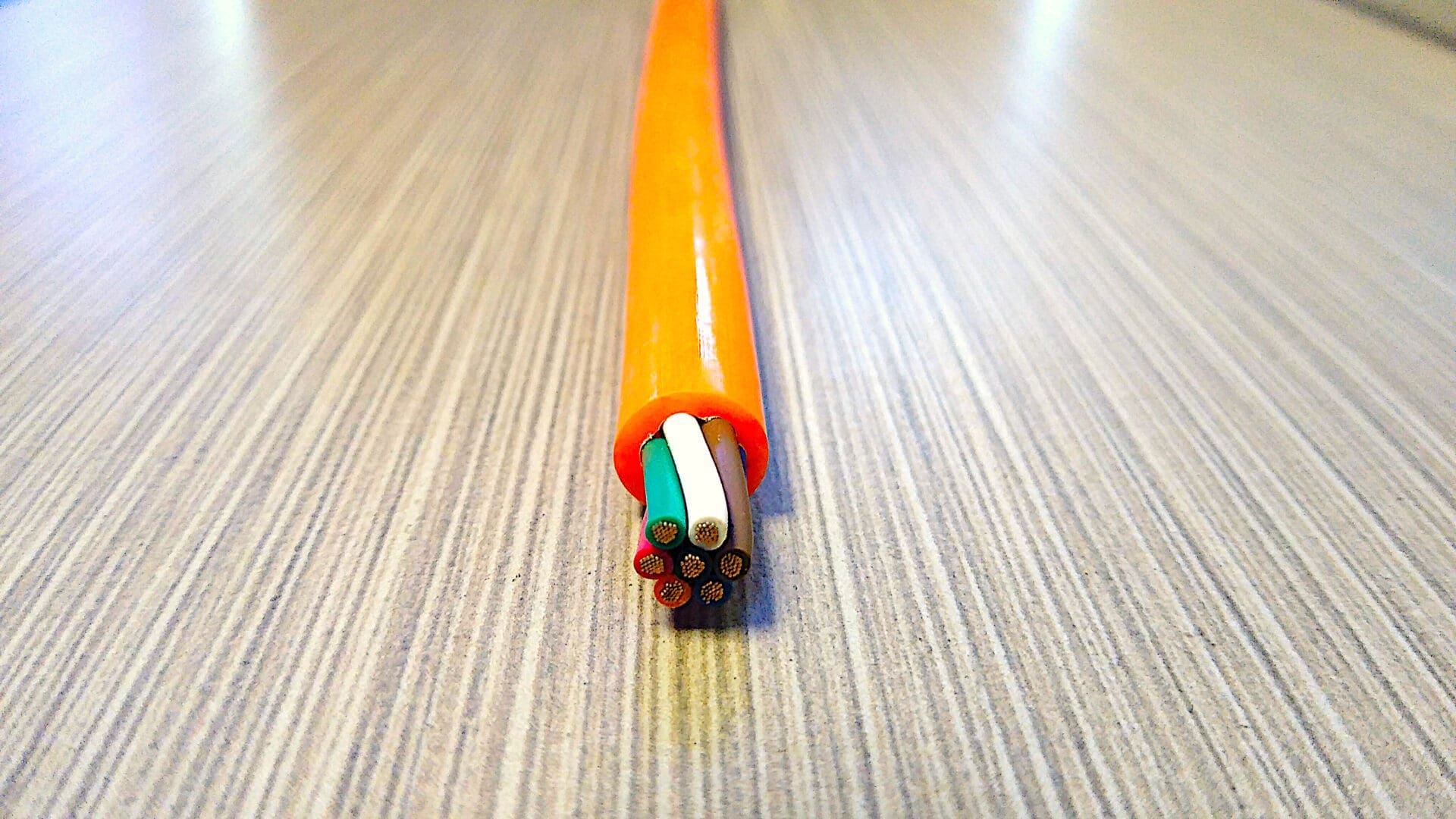 A PCE167 16 GA 7 COND. 300V COIL CABLE MAX DUTY is sitting on top of a table.