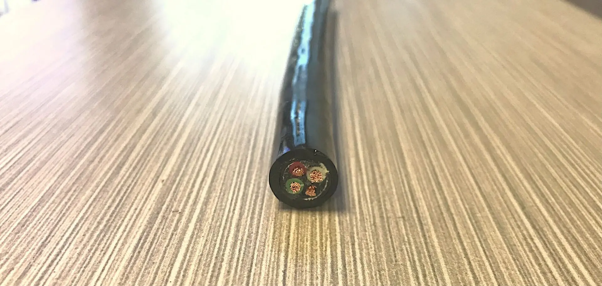 A black cable sitting on top of a table.