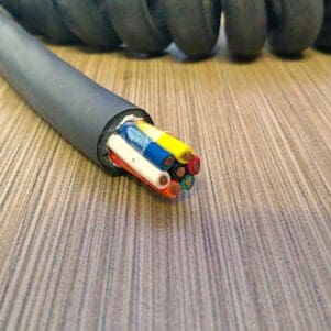 A PCO147 - Power Coiled Cord 14 Gauge with 7 Conductors - No Shield - 600 Volts on top of a table.