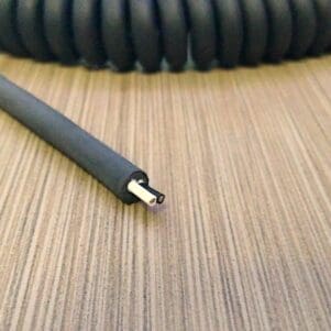 A PCV182 Power Coiled Cord 18 Gauge with 2 Conductors - Non - Shielded on top of a table.