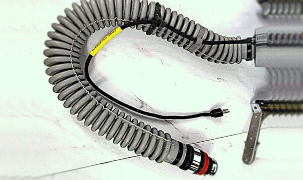 A coiled hose with a wire attached to it.