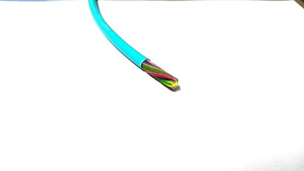 A piece of paper with a FiOps300-24F - Aqua Blue sticking out of it.