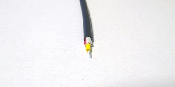 A FiOps310-6F - Black wire on a white surface.