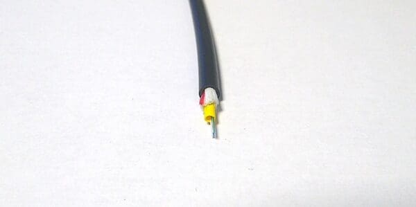 A FiOps310-6F - Black wire on a white surface.