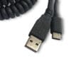 A black coiled USB-A to USB-C Connector Combo (Connectors Only) cable connected to a device.