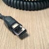 A black USB-A to USB-C Connector Combo (Connectors Only) cable is laying on top of a table.
