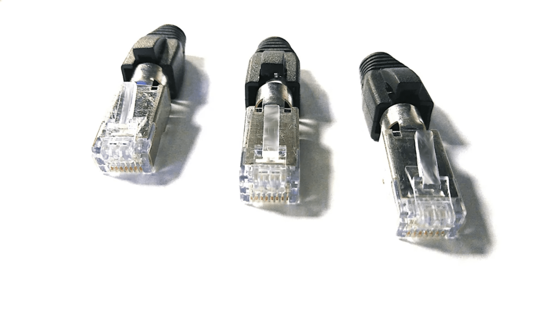 Three Sci-Flex© Ethernet cables with Category 6A/6 RJ45 plugs and transparent connectors on a white background.