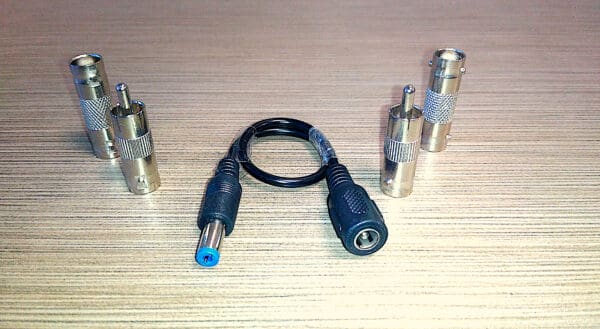 An array of Video Security Camera Wire with Connectors for CCTV Camera DVR Surveillance System and a patch cable on a wooden surface.