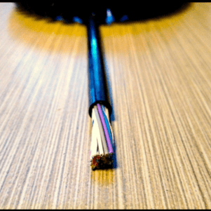 Cut black cable with exposed colored wires